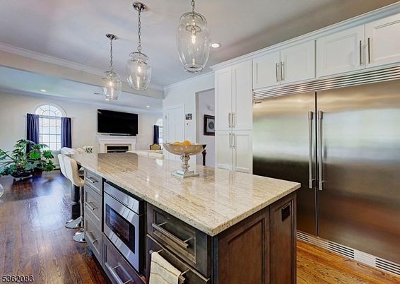 Dining room, Fireplace, Interior, Kitchen, Pendant Lights, Recessed Lighting, Stainless Steel Appliances, Wood Texture Flooring