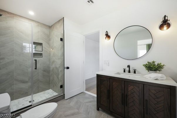 Bathroom, Dual Sink Vanities, Glass Shower, Interior, Marble Walls, Recessed Lighting, Wood Texture Flooring