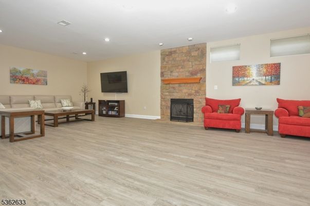 Fireplace, Interior, Living room, Recessed Lighting, Stone Walls, Wood Texture Flooring
