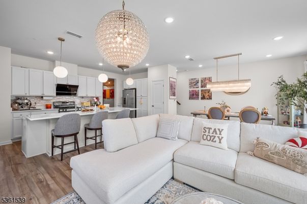 Chandelier, Dining room, Interior, Kitchen, Living room, Pendant Lights, Recessed Lighting, Stainless Steel Appliances, Wood Texture Flooring