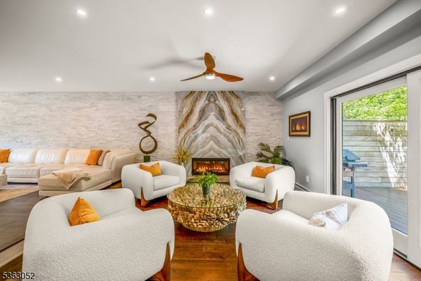 Fireplace, Interior, Living room, Recessed Lighting, Stone Walls, Wood Texture Flooring