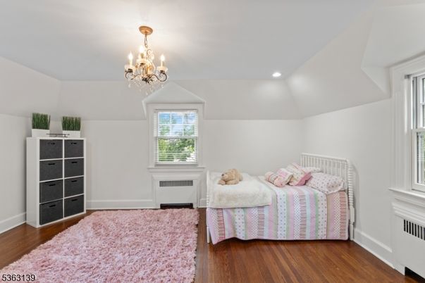 Bedroom, Chandelier, Fireplace, Interior, Recessed Lighting, Wood Texture Flooring