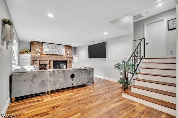 Fireplace, Interior, Living room, Recessed Lighting, Stone Walls, Wood Texture Flooring