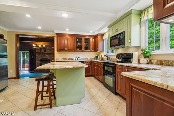 Fireplace, Interior, Kitchen, Recessed Lighting, Stainless Steel Appliances, Stone Walls