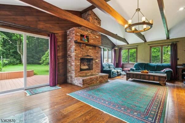 Chandelier, Fireplace, Interior, Living room, Pendant Lights, Recessed Lighting, Stone Walls, Wooden Beams, Wood Texture Flooring