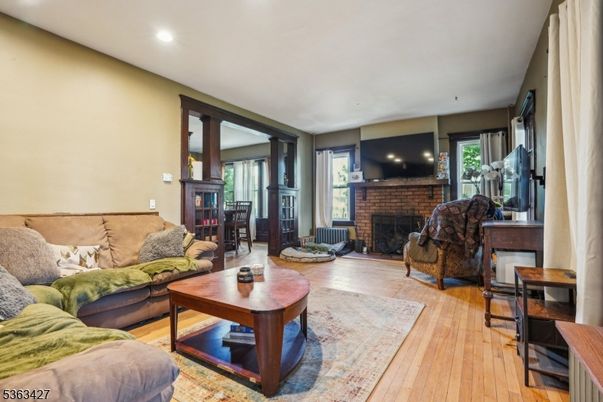 Fireplace, Interior, Living room, Recessed Lighting, Stone Walls, Wood Texture Flooring