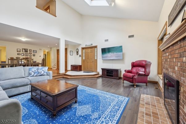 Dining room, Fireplace, Interior, Living room, Recessed Lighting, Stone Walls, Wood Texture Flooring