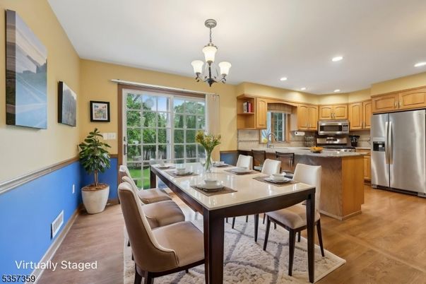 Chandelier, Dining room, Interior, Kitchen, Recessed Lighting, Stainless Steel Appliances, Wood Texture Flooring