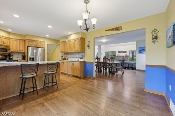 Chandelier, Dining room, Interior, Kitchen, Pendant Lights, Recessed Lighting, Stainless Steel Appliances, Wood Texture Flooring