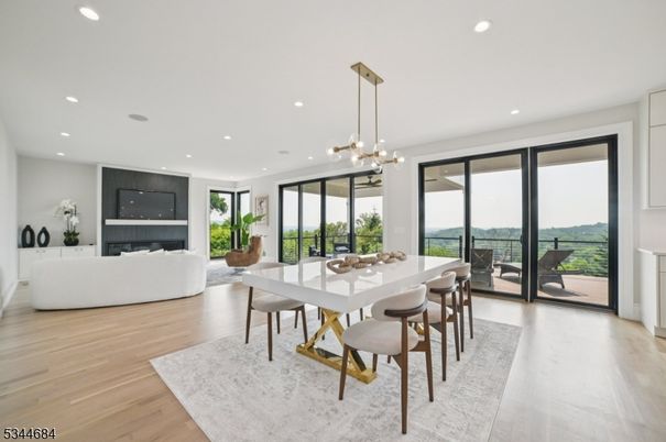 Dining room, Fireplace, Interior, Living room, Pendant Lights, Recessed Lighting, Wood Texture Flooring