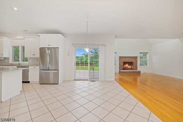 Empty room, Fireplace, Interior, Kitchen, Pendant Lights, Recessed Lighting, Stainless Steel Appliances