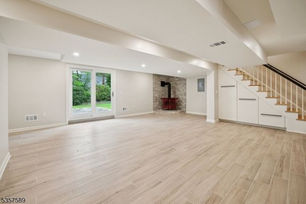 Empty room, Fireplace, Interior, Recessed Lighting, Stone Walls, Wood Texture Flooring