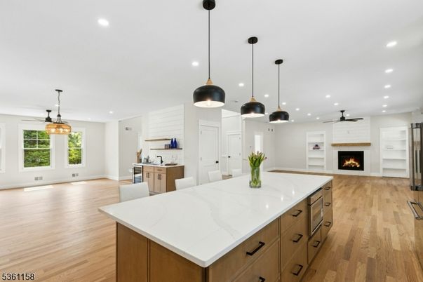 Empty room, Fireplace, Interior, Kitchen, Pendant Lights, Recessed Lighting, Wood Texture Flooring