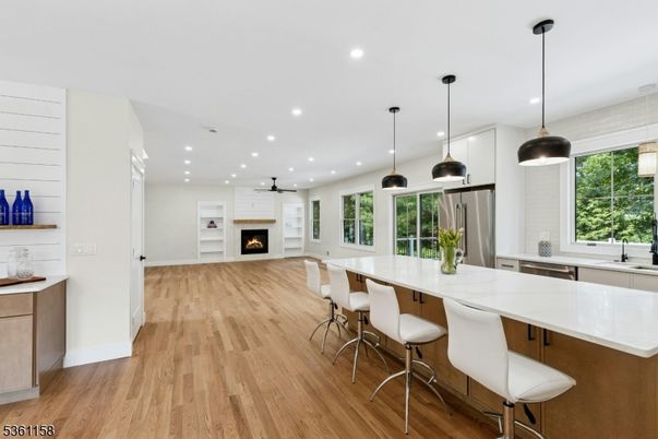 Dining room, Fireplace, Interior, Kitchen, Pendant Lights, Recessed Lighting, Stainless Steel Appliances, Wood Texture Flooring