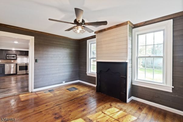 Empty room, Fireplace, Interior, Kitchen, Stainless Steel Appliances, Wood Texture Flooring