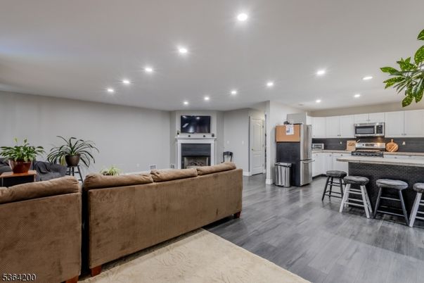 Fireplace, Interior, Kitchen, Living room, Recessed Lighting, Stainless Steel Appliances, Wood Texture Flooring