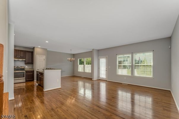 Chandelier, Empty room, Interior, Kitchen, Recessed Lighting, Stainless Steel Appliances, Wood Texture Flooring