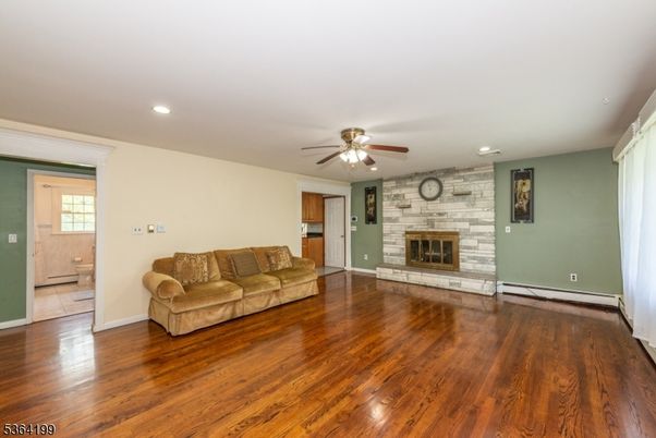 Empty room, Fireplace, Interior, Recessed Lighting, Stone Walls, Wood Texture Flooring