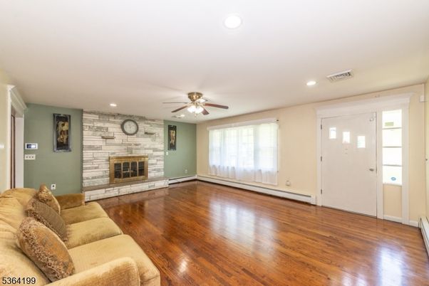 Empty room, Fireplace, Interior, Living room, Recessed Lighting, Stone Walls, Wood Texture Flooring