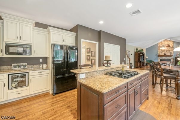 Dining room, Fireplace, Interior, Kitchen, Recessed Lighting, Stone Walls, Wood Texture Flooring