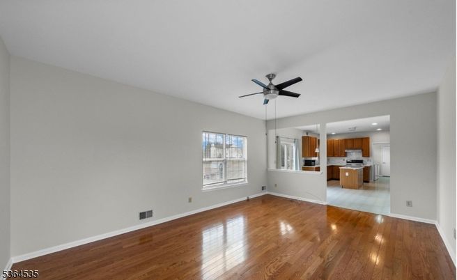 Empty room, Interior, Kitchen, Recessed Lighting, Stainless Steel Appliances, Wood Texture Flooring