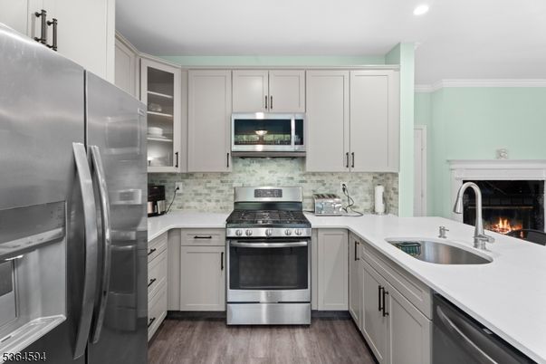 Fireplace, Interior, Kitchen, Recessed Lighting, Stainless Steel Appliances, Wood Texture Flooring