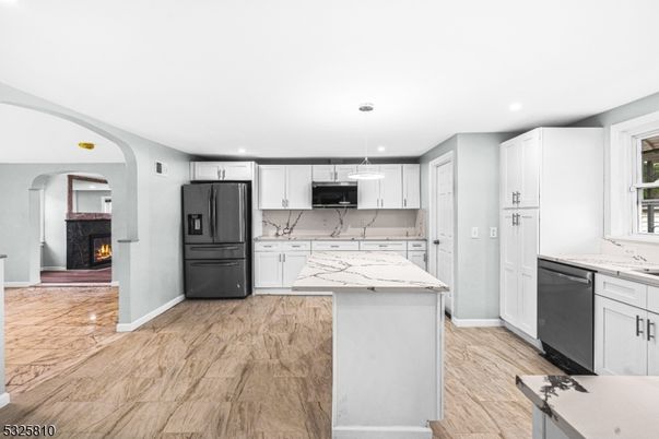 Fireplace, Interior, Kitchen, Marble Walls, Pendant Lights, Recessed Lighting, Stainless Steel Appliances, Wood Texture Flooring