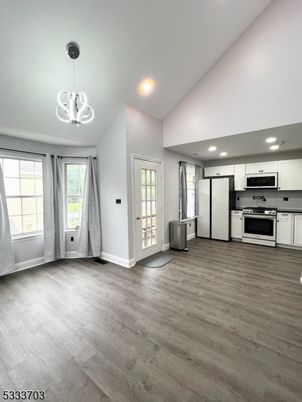 Empty room, Interior, Kitchen, Pendant Lights, Recessed Lighting, Stainless Steel Appliances, Wood Texture Flooring