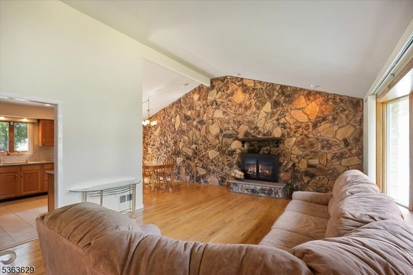 Chandelier, Dining room, Fireplace, Interior, Living room, Stone Walls, Wood Texture Flooring