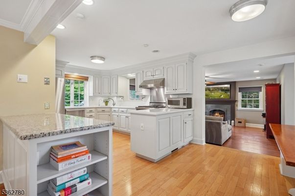 Fireplace, Interior, Kitchen, Living room, Recessed Lighting, Stainless Steel Appliances, Wood Texture Flooring