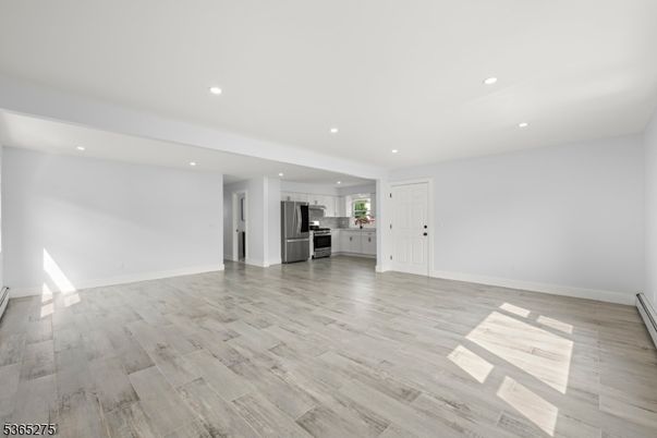 Empty room, Interior, Kitchen, Recessed Lighting, Stainless Steel Appliances, Wood Texture Flooring