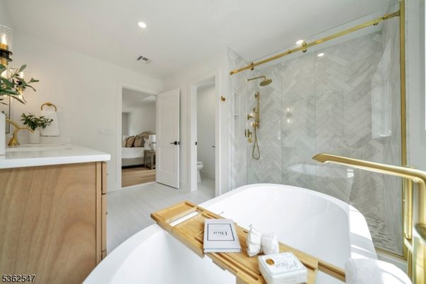 Bathroom, Free Standing Baths, Glass Shower, Interior, Marble Walls, Recessed Lighting, Wood Texture Flooring