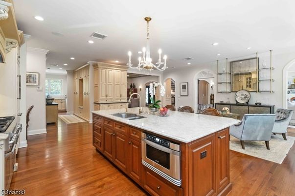 Chandelier, Interior, Kitchen, Living room, Recessed Lighting, Stainless Steel Appliances, Wood Texture Flooring