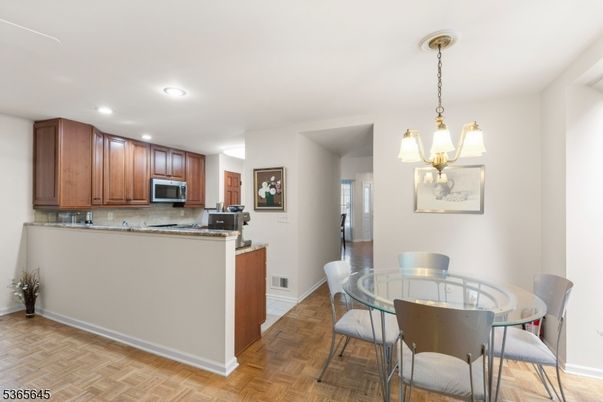 Dining room, Interior, Kitchen, Pendant Lights, Recessed Lighting, Stainless Steel Appliances, Wood Texture Flooring