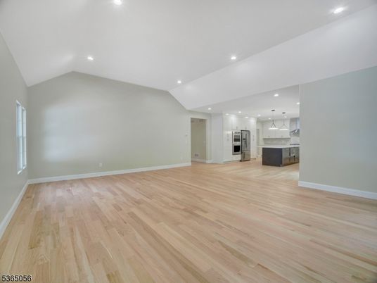 Empty room, Interior, Kitchen, Pendant Lights, Recessed Lighting, Stainless Steel Appliances, Wood Texture Flooring