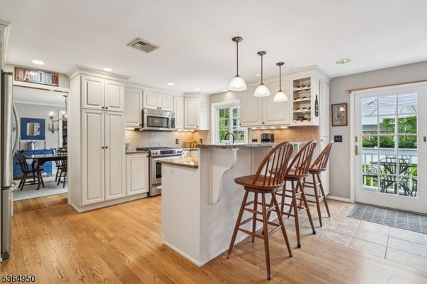 Dining room, Interior, Kitchen, Pendant Lights, Recessed Lighting, Stainless Steel Appliances, Wood Texture Flooring