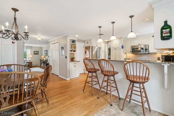 Chandelier, Dining room, Interior, Kitchen, Pendant Lights, Recessed Lighting, Stainless Steel Appliances, Wood Texture Flooring