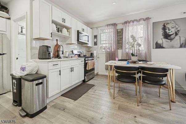 Dining room, Interior, Kitchen, Recessed Lighting, Stainless Steel Appliances, Wood Texture Flooring