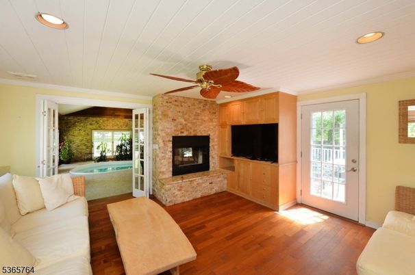 Fireplace, Interior, Living room, Recessed Lighting, Stone Walls, Wood Texture Flooring