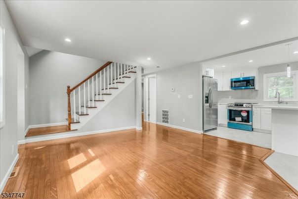 Empty room, Interior, Kitchen, Pendant Lights, Recessed Lighting, Stainless Steel Appliances, Wood Texture Flooring