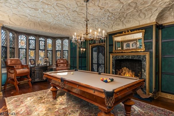 Billiard Table, Chandelier, Fireplace, Game Room, Interior, Wood Texture Flooring