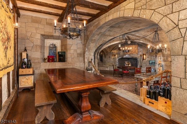 Chandelier, Dining room, Fireplace, Interior, Pendant Lights, Stone Walls, Wooden Beams, Wood Texture Flooring