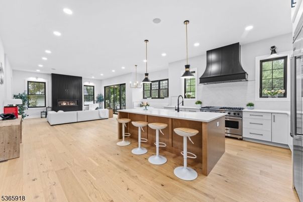Fireplace, Interior, Kitchen, Living room, Pendant Lights, Recessed Lighting, Stainless Steel Appliances, Wood Texture Flooring