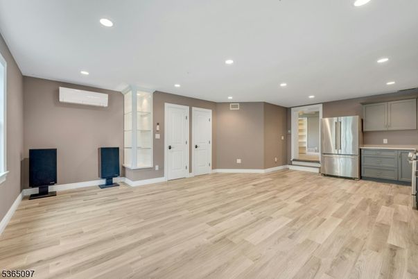 Empty room, Interior, Kitchen, Recessed Lighting, Stainless Steel Appliances, Wood Texture Flooring