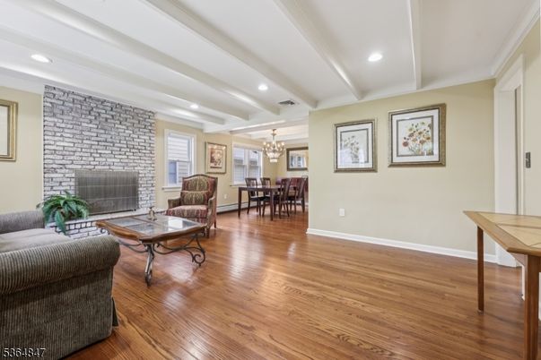 Chandelier, Dining room, Fireplace, Interior, Living room, Recessed Lighting, Stone Walls, Wood Texture Flooring