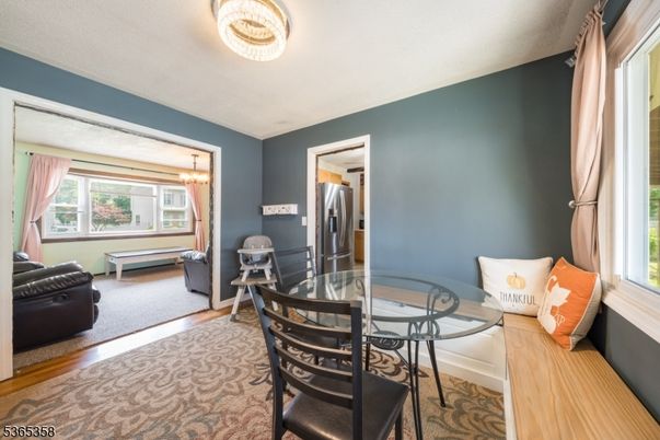 Chandelier, Dining room, Interior, Kitchen, Stainless Steel Appliances, Wood Texture Flooring