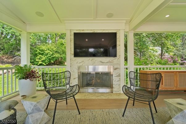 Fireplace, Interior, Marble Walls, Recessed Lighting, Sun Room, Wood Texture Flooring
