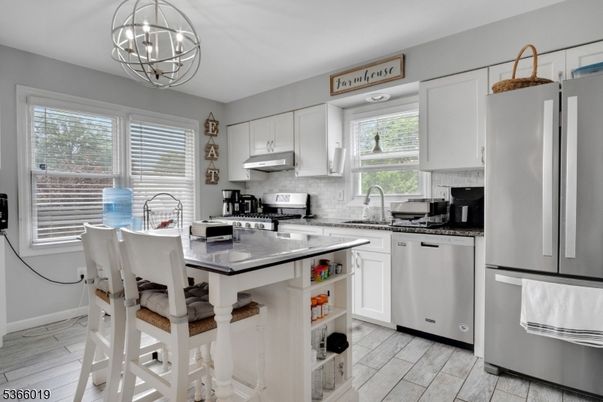 Chandelier, Dining room, Interior, Kitchen, Pendant Lights, Stainless Steel Appliances, Wood Texture Flooring