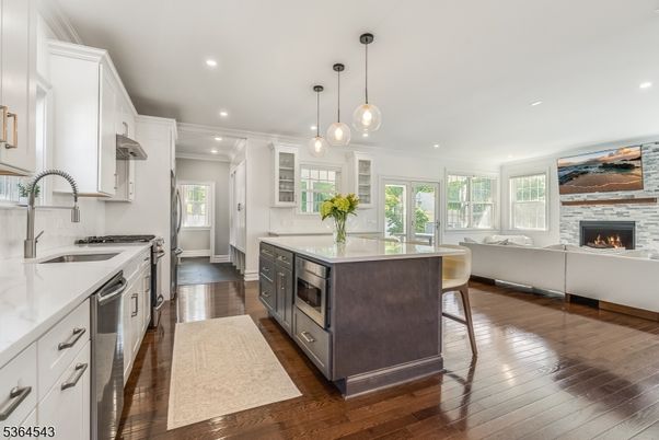 Fireplace, Interior, Kitchen, Pendant Lights, Recessed Lighting, Stainless Steel Appliances, Stone Walls, Wood Texture Flooring