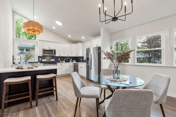 Chandelier, Dining room, Interior, Kitchen, Pendant Lights, Recessed Lighting, Stainless Steel Appliances, Wood Texture Flooring